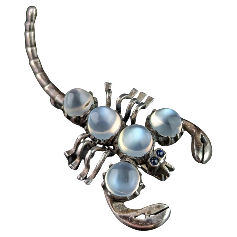 Antique Sterling silver and Moonstone scorpion brooch, blue paste eyes